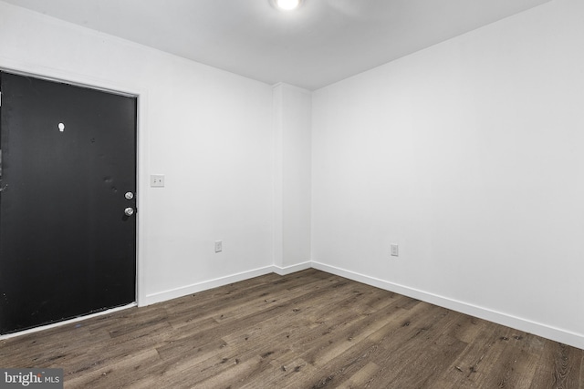 spare room with dark hardwood / wood-style floors