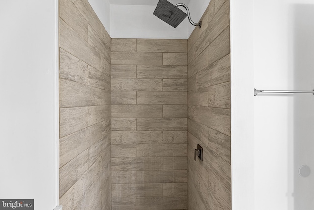 interior details featuring tiled shower