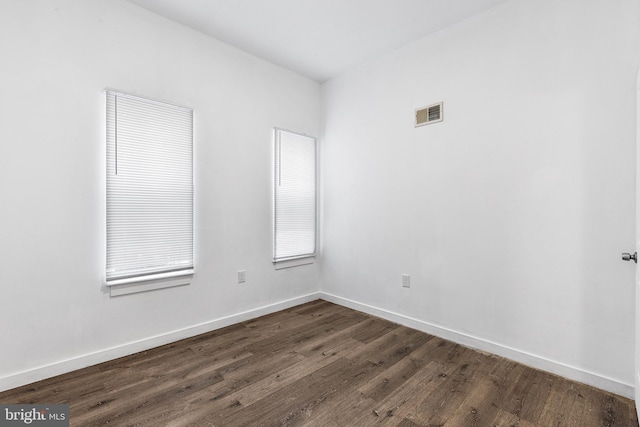 unfurnished room featuring dark hardwood / wood-style flooring