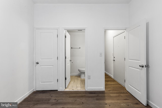 interior space featuring hardwood / wood-style floors and toilet