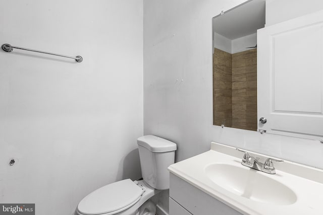 bathroom featuring toilet and vanity