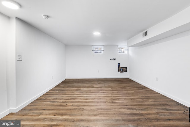 basement featuring dark hardwood / wood-style flooring