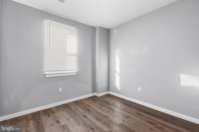 spare room featuring plenty of natural light and hardwood / wood-style floors