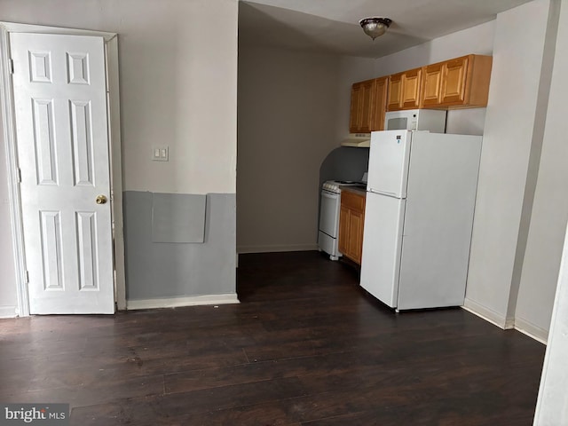 kitchen featuring dark hardwood / wood-style flooring and white appliances