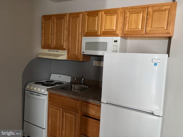 kitchen featuring tasteful backsplash, white appliances, and sink