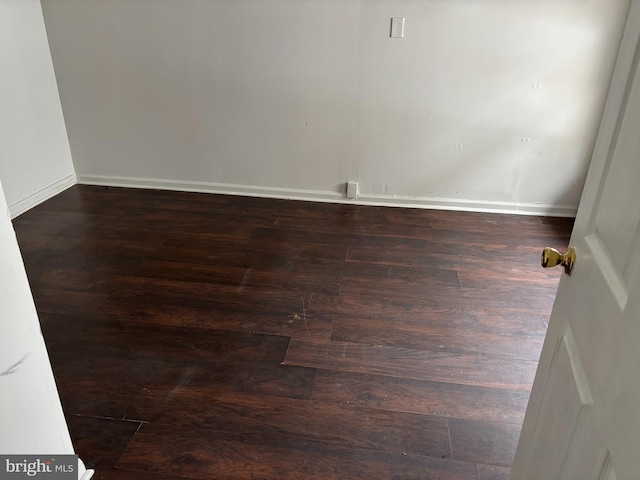 empty room featuring dark wood-type flooring