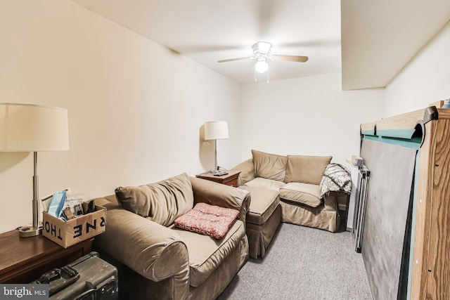 carpeted living room with ceiling fan