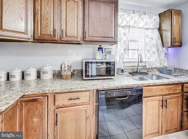 kitchen featuring sink, tile patterned floors, and black dishwasher