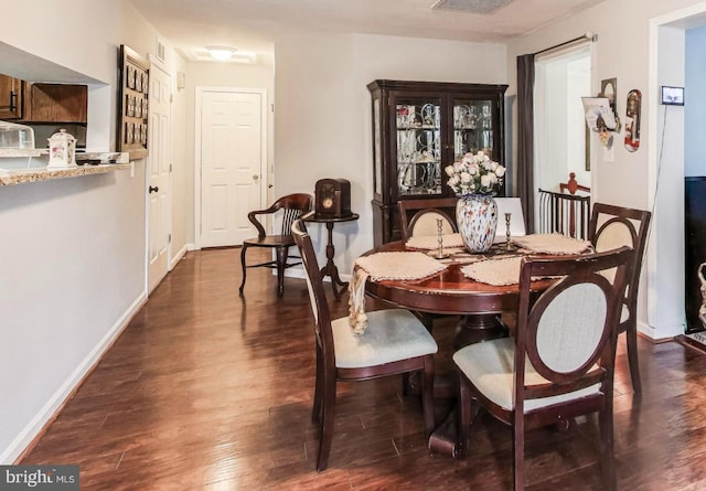 dining space featuring dark wood-type flooring