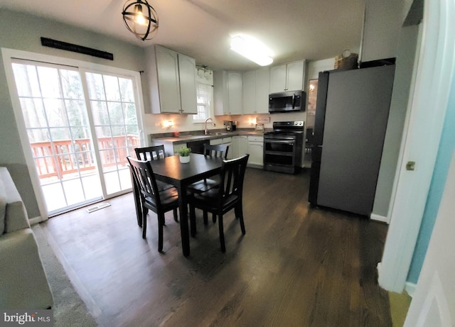 dining room featuring dark hardwood / wood-style floors and sink