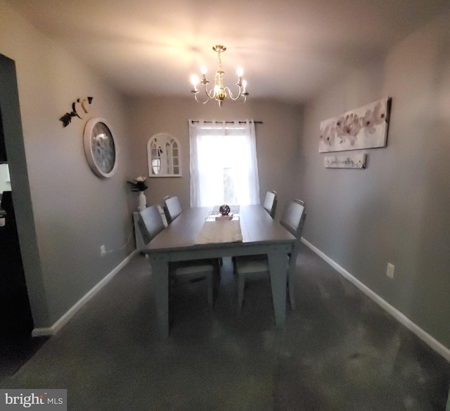 dining space with a notable chandelier and dark colored carpet