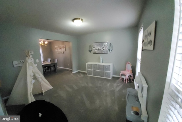 interior space with dark carpet and a notable chandelier