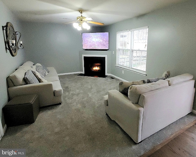 carpeted living room featuring ceiling fan