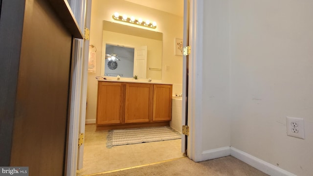 bathroom featuring ceiling fan and vanity