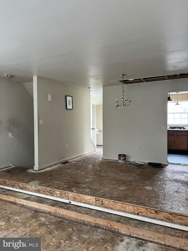 unfurnished living room with a notable chandelier