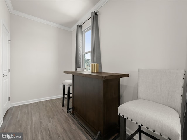 interior space with hardwood / wood-style flooring and ornamental molding