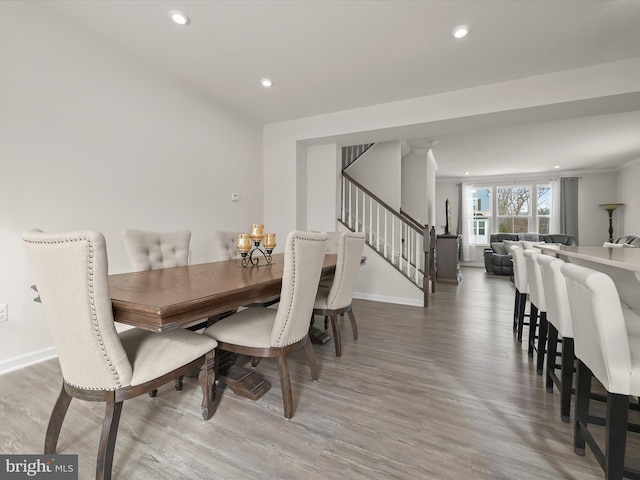 dining space featuring hardwood / wood-style flooring and crown molding