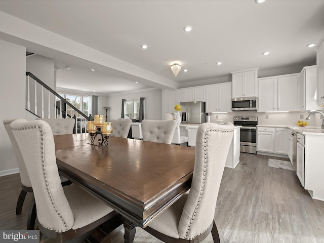 dining space with sink and light hardwood / wood-style flooring