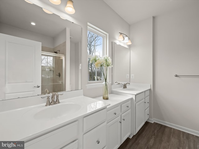 bathroom with vanity, a wealth of natural light, walk in shower, and hardwood / wood-style floors