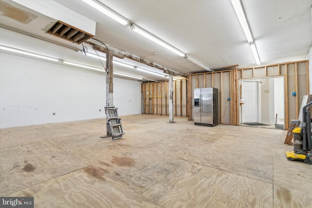 garage with stainless steel fridge