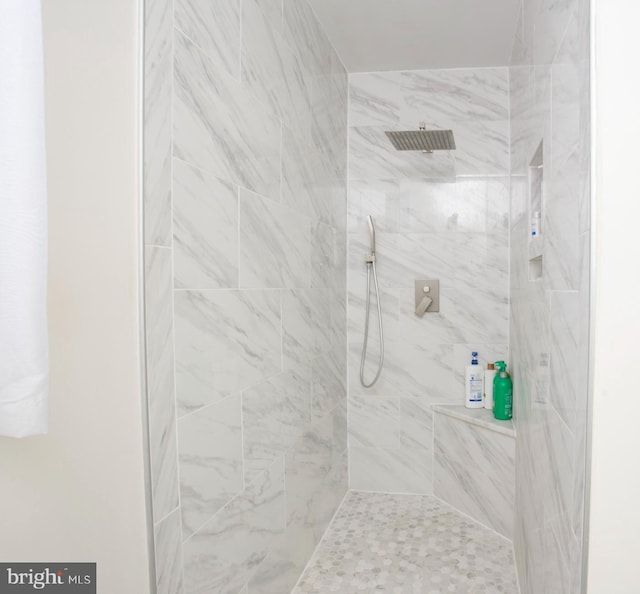 bathroom with a tile shower