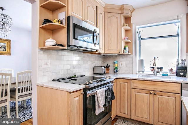 kitchen with appliances with stainless steel finishes, sink, decorative backsplash, light stone counters, and light brown cabinets