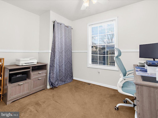 carpeted office space featuring ceiling fan