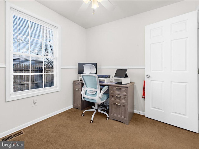 carpeted home office featuring ceiling fan