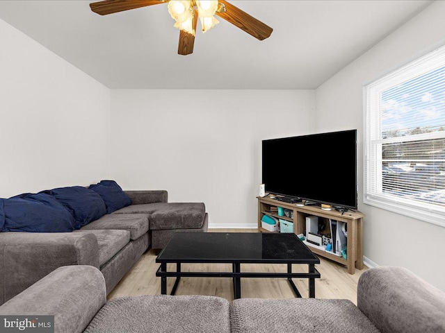 living room with light wood-type flooring and ceiling fan