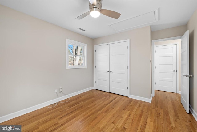 unfurnished bedroom with light hardwood / wood-style flooring, ceiling fan, and a closet