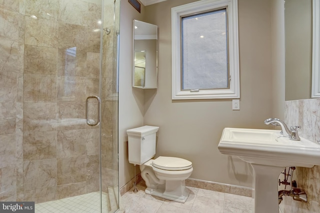 bathroom with a shower with door, ornamental molding, and toilet