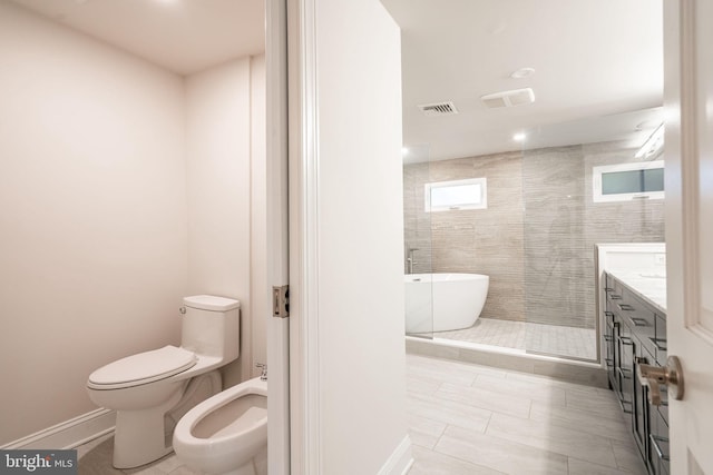 full bathroom featuring tile patterned floors, toilet, a bidet, vanity, and independent shower and bath