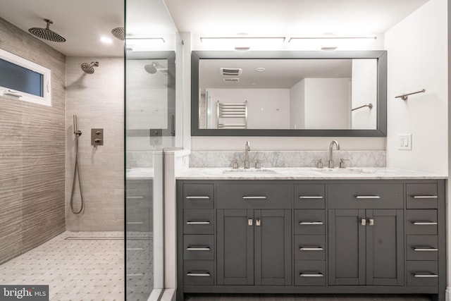 bathroom featuring vanity and a tile shower