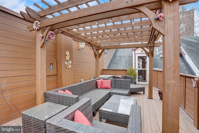 wooden deck with an outdoor living space and a pergola