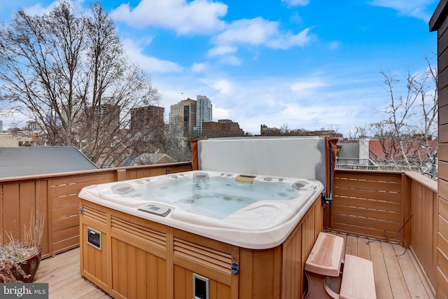 wooden deck with a hot tub