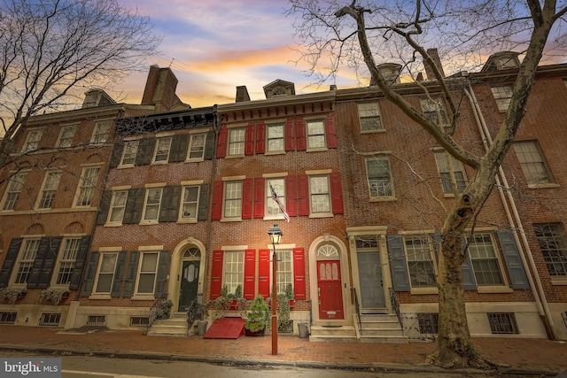 view of outdoor building at dusk