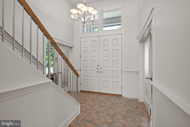 entryway featuring a notable chandelier and a wealth of natural light