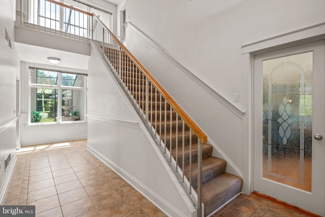 staircase featuring tile patterned flooring