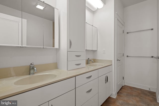 bathroom with tile patterned floors and vanity