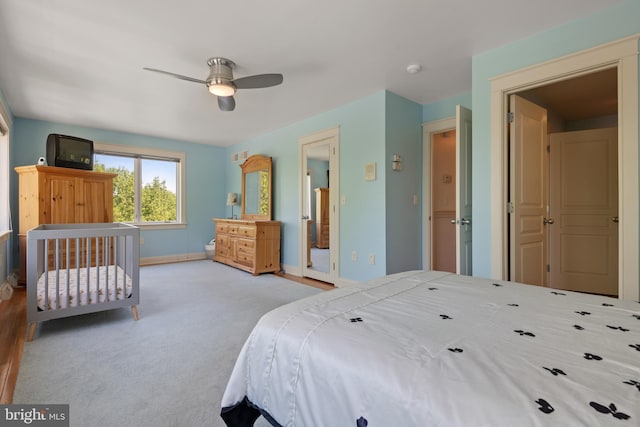 bedroom with ceiling fan and light colored carpet