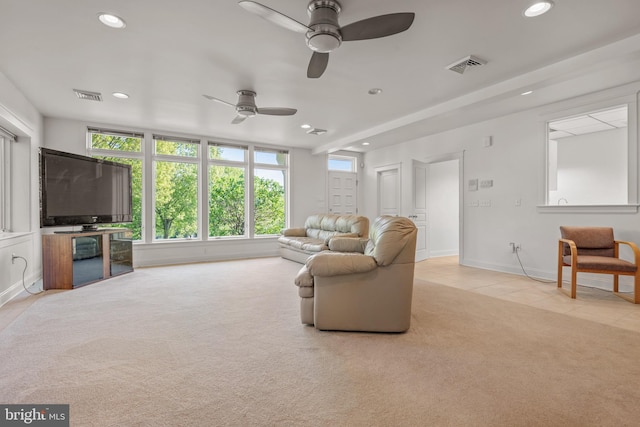 carpeted living room with ceiling fan