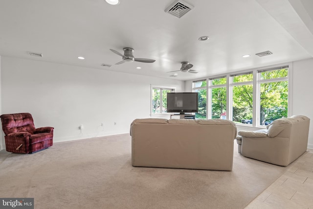 carpeted living room featuring ceiling fan