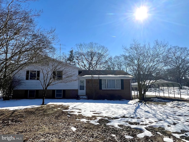 split level home with a carport and brick siding