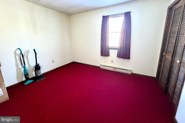 carpeted empty room with a baseboard radiator