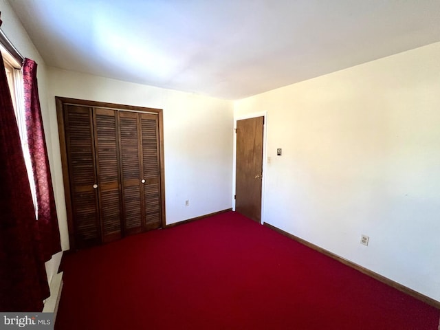 unfurnished bedroom with carpet and a closet