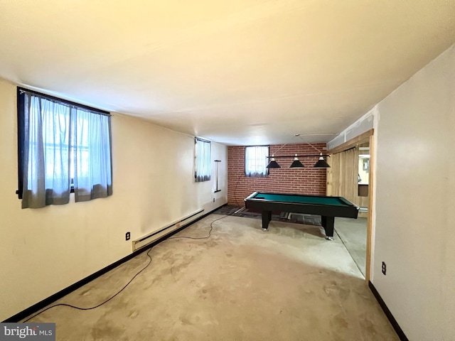 recreation room with a baseboard heating unit, pool table, plenty of natural light, and brick wall