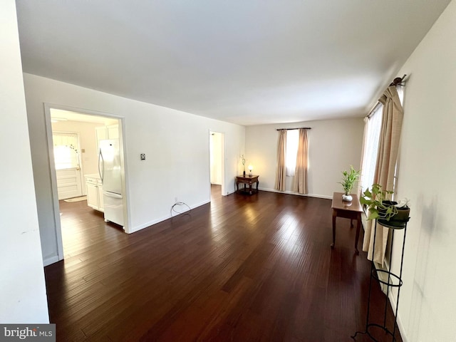 living room featuring a healthy amount of sunlight and dark hardwood / wood-style floors