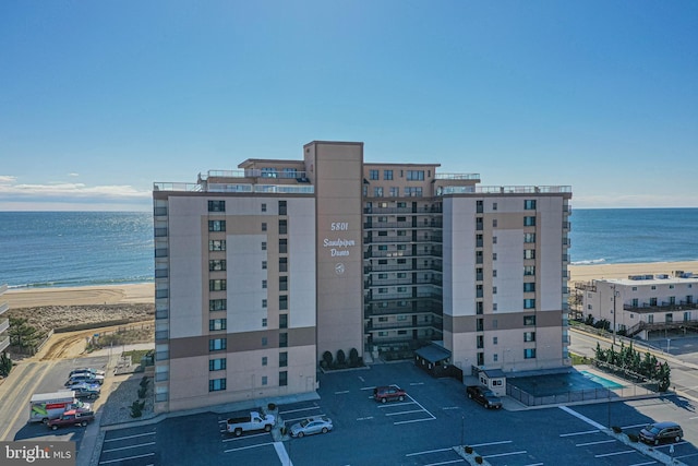 view of property with a view of the beach and a water view