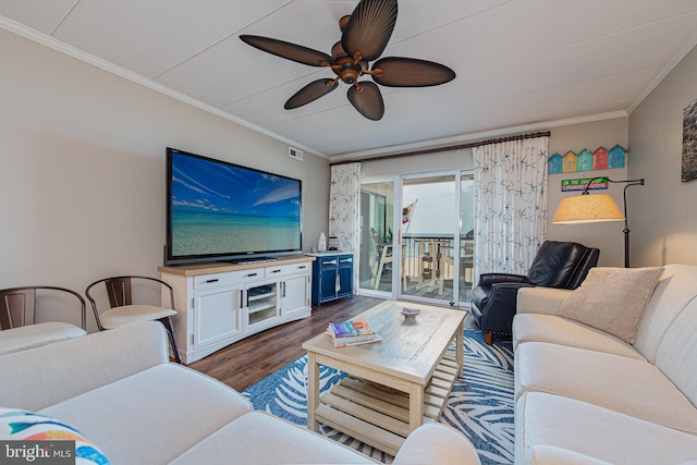 living room with crown molding, ceiling fan, and dark hardwood / wood-style floors