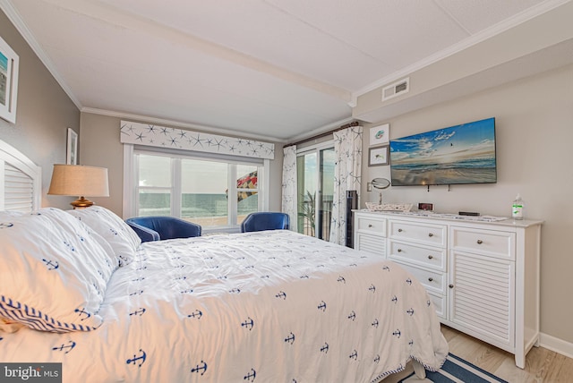 bedroom featuring crown molding and light wood-type flooring